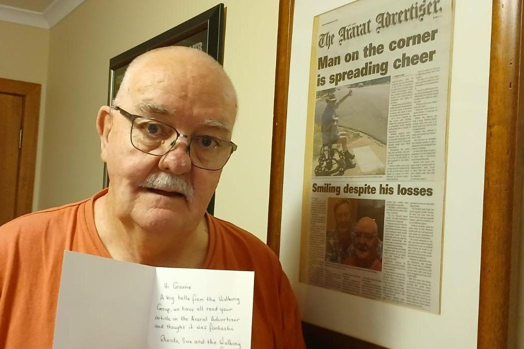 Ararat's Graeme Bailey with his framed copy of the Ararat Advertiser he featured in on February 14 2025 and a hand written card from the Ararat Walking Group Picture supplied