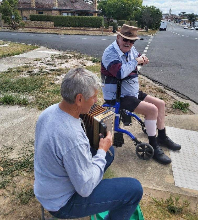 Graeme Bailey with his neighbours sicking on the street corner in Ararat, bringing cheer to others. Picture supplied.