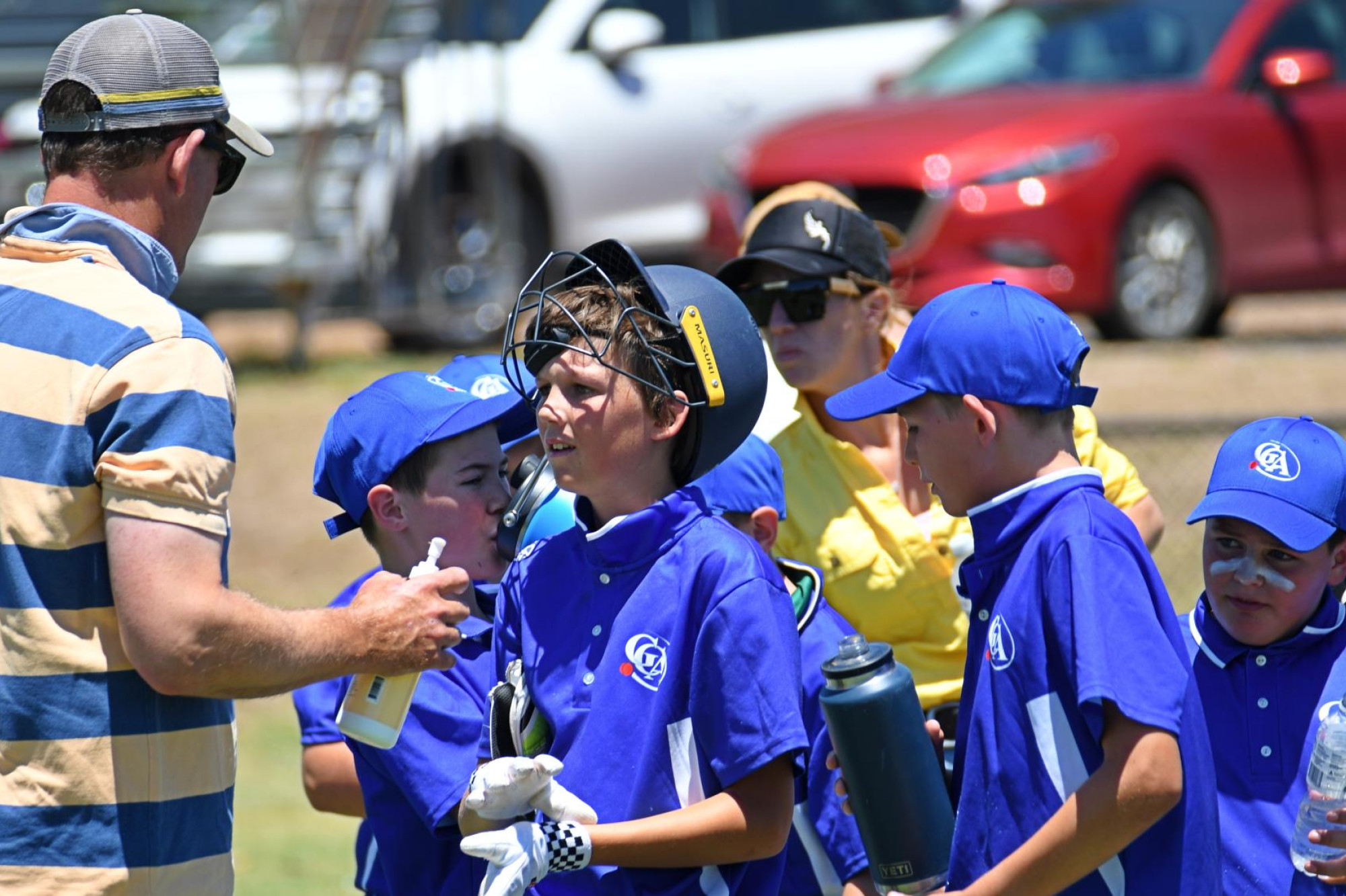 Andy Tucker gives son Max some encouraging words during a drinks break. Picture by Ben Fraser