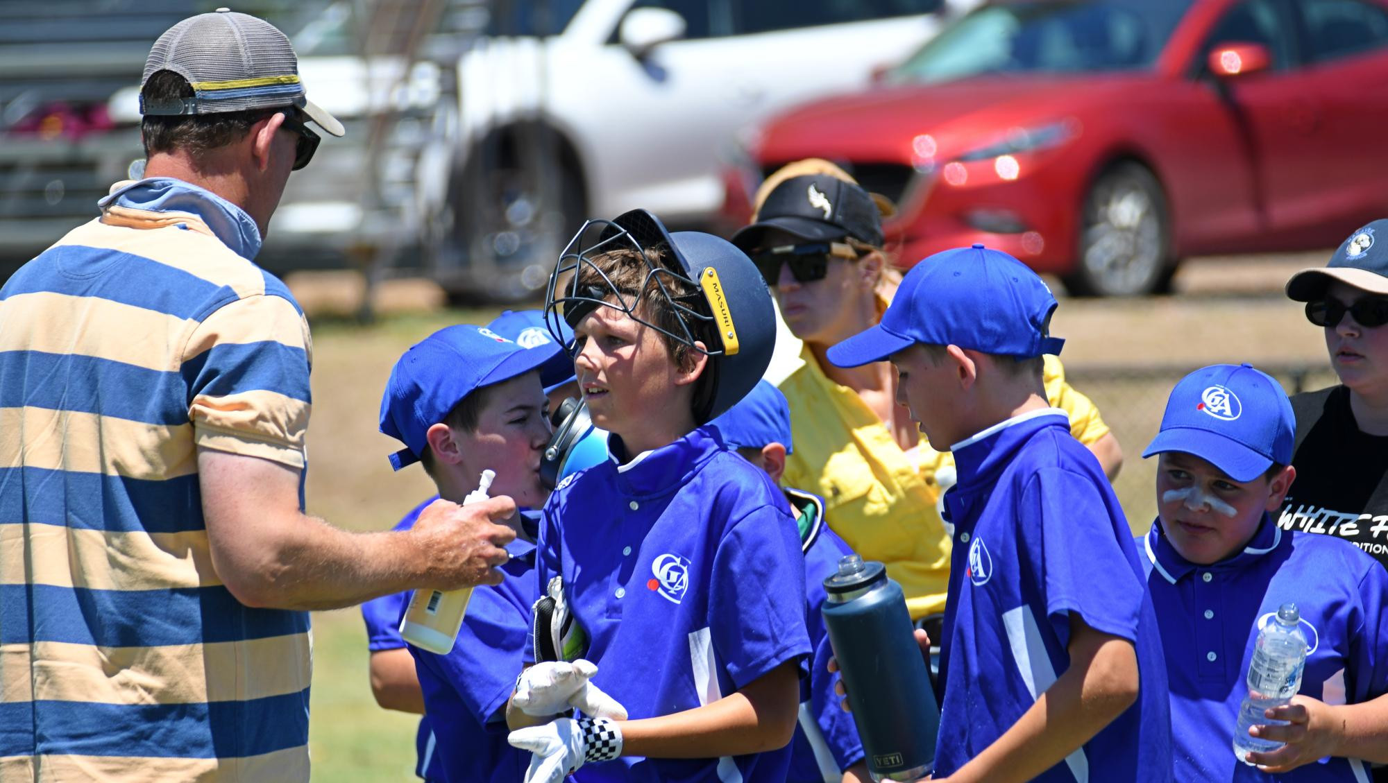 Andy Tucker gives son Max some encouraging words during a drinks break. Picture by Ben Fraser