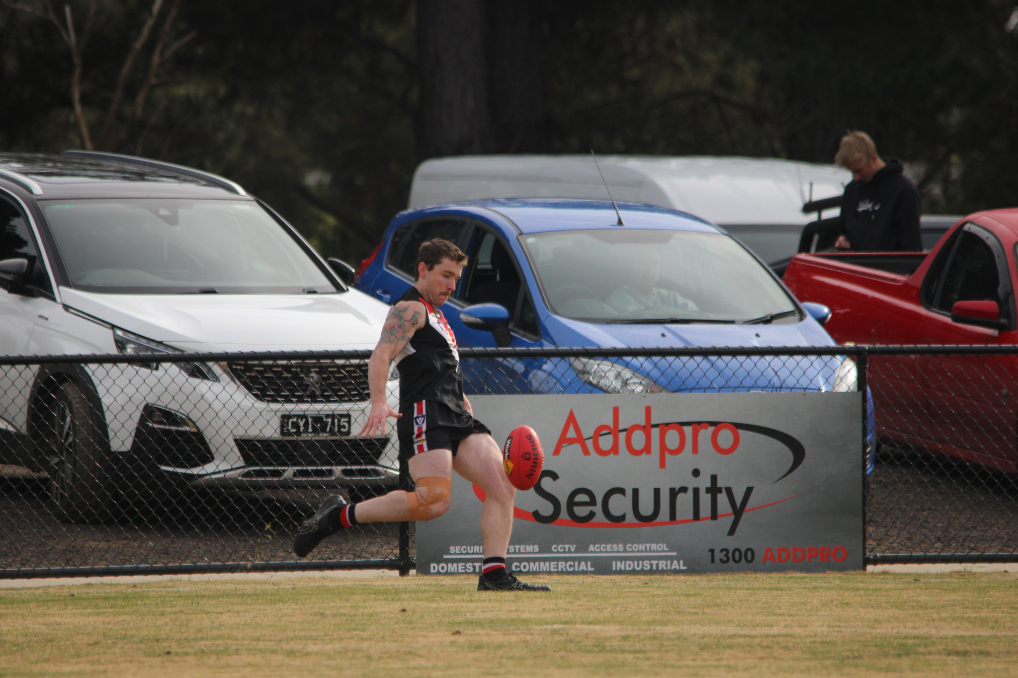 Jayden Bound (Saints) gets a clearing kick from defence. PHOTO: CHRIS GRAETZ