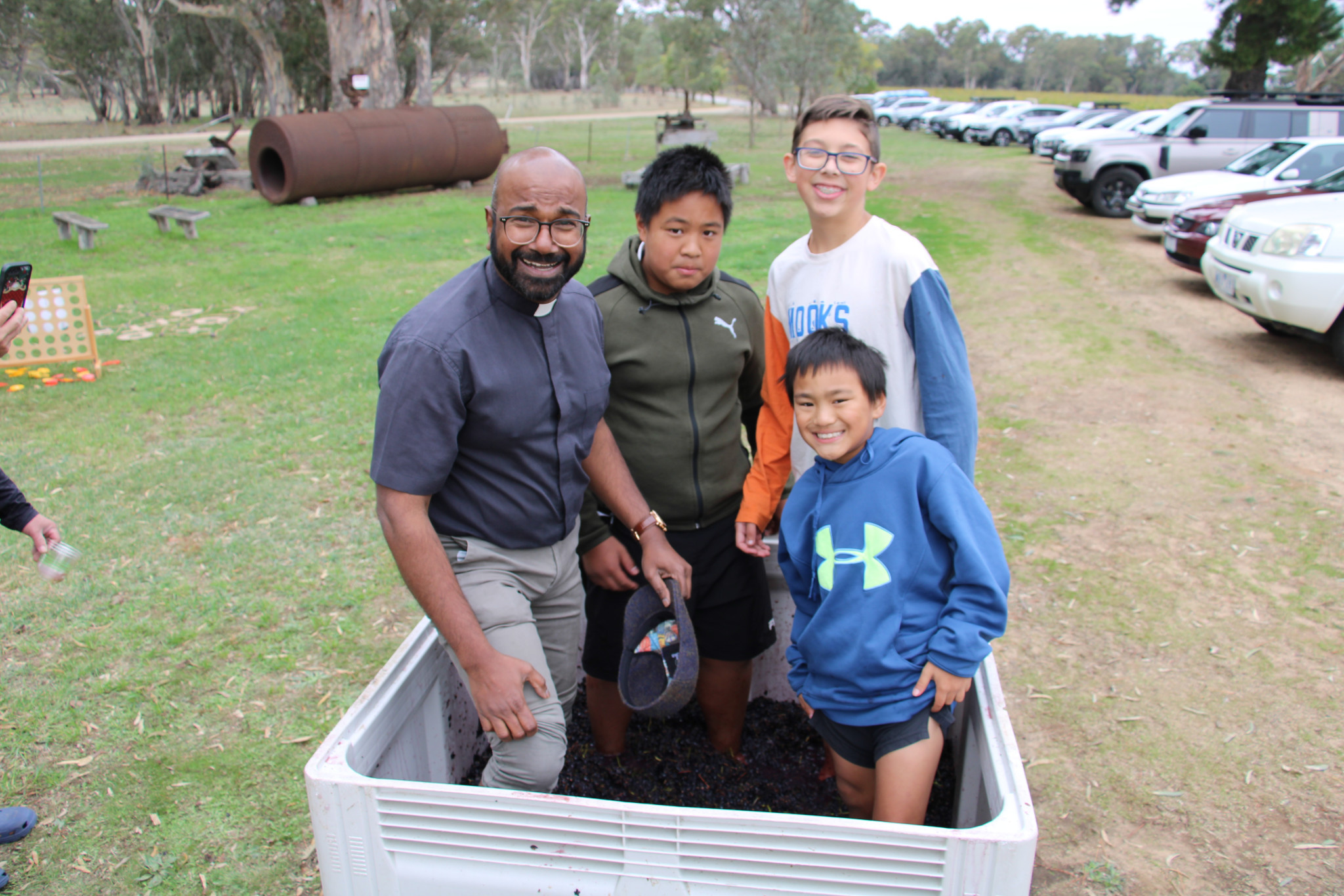 Fr Martin Nadarajan, join Simon, Inari and Sallow in the traditional grape squash.