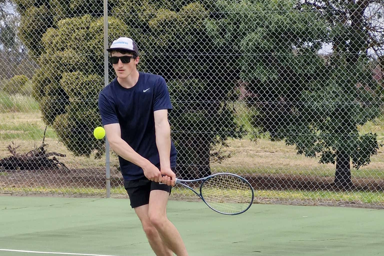 Elmhurst-Amphitheatre’s Will Edgar concentrates as he prepares to hit a winner. Photo by Mel Murnane.