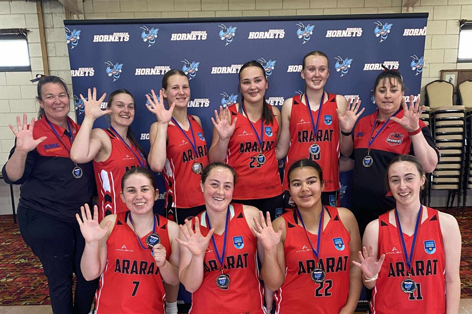 The under-18 girls celebrate their fifth consecutive win. Back L-R: Casanda Woods (Coach), Addison Lardner, Ruby Thomas, Eleanor Sladdin, Bridie Price, Ros Thomas (Team Manager): Front L-R: Mackenzie Johnson, Nevani Woods, Violet Day, Mia Gardiner.