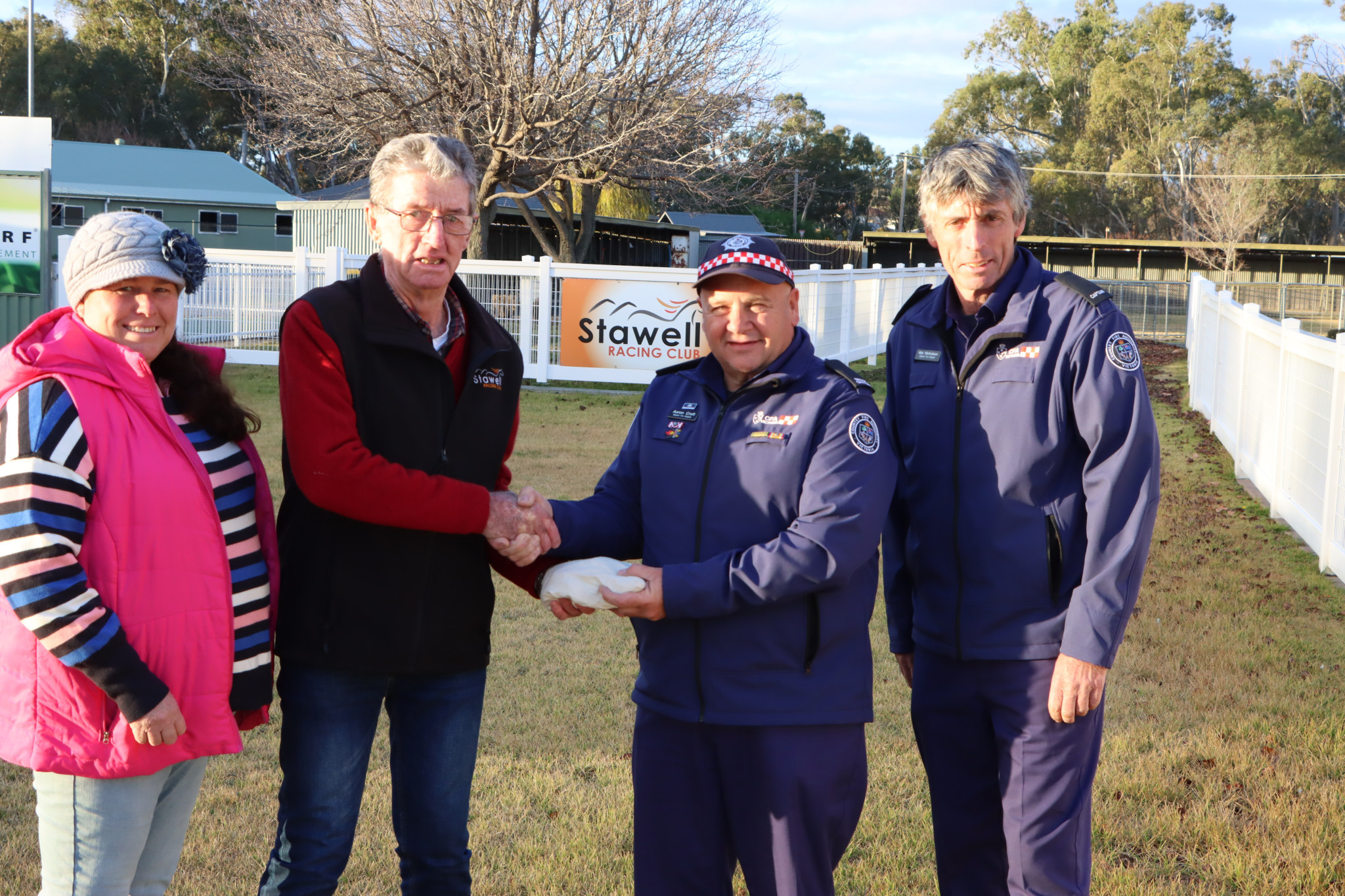 Stawell Racing Club’s Rachel Samsonenko and Ian Nicholson hand over the takings from the Halls Gap Cup to Group Officer Aaron Croft and Stawell Captain Mal Nicholson.