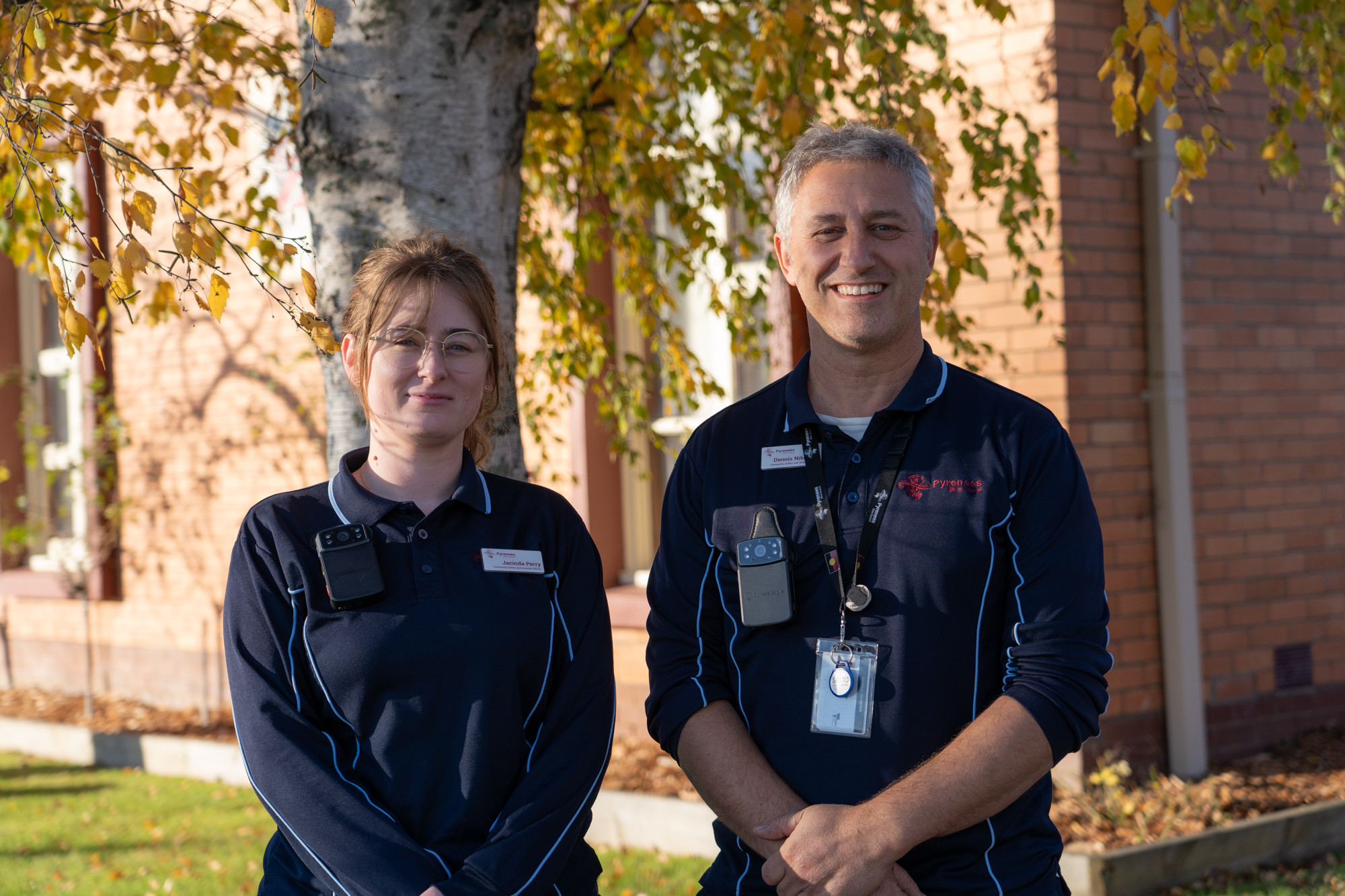 Council officers Jacinda Perry and Dennis Nikoltsis show off the new body cameras introduced by Pyrenees Shire Council.
