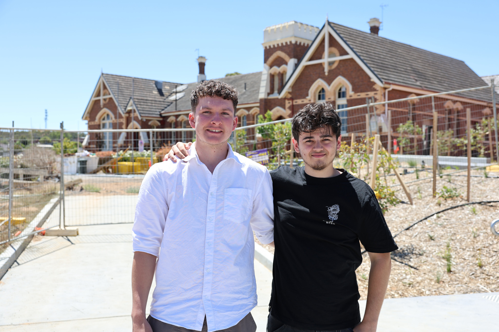Seth Manns and Caleb Cassar outside the original school building at Stawell Secondary College, now undergoing renovation &mdash; the place where their friendship grew and a decade-long journey toward university took shape.
