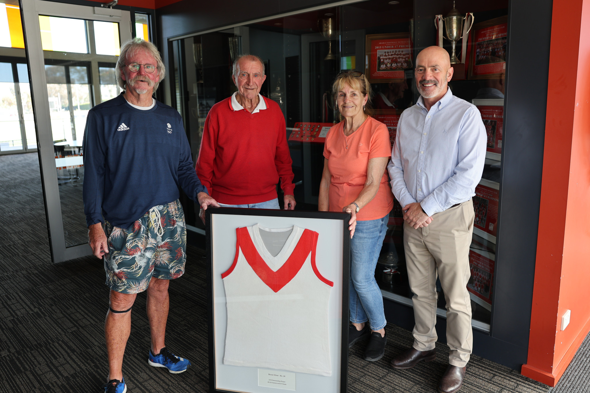 Jike Jones, Bruce Olver's premiership coach Wilf Dickison, Bruce’s sister Tina Gibson and Ararat Football Netball Club president David Hosking, gathered for Jike to present the Ararat Rats with a jumper Bruce gave him following the 1975 Wimmera Football League grand final.