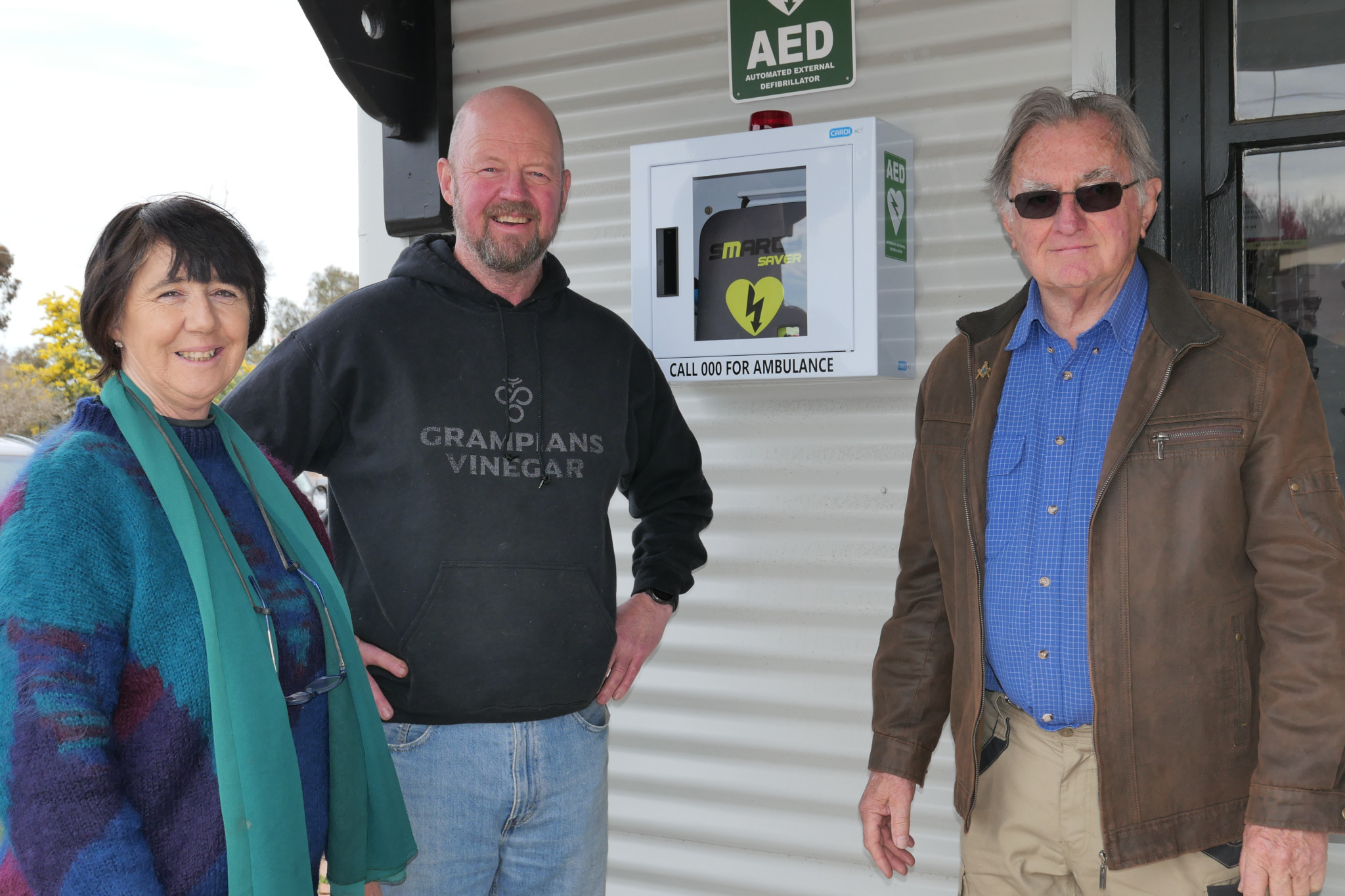 Great Western Future Committee member Anthony Kumnick (centre), Sonya Camps (left) and David Richardson are happy to see a new automated external defibrillator in Main Street.