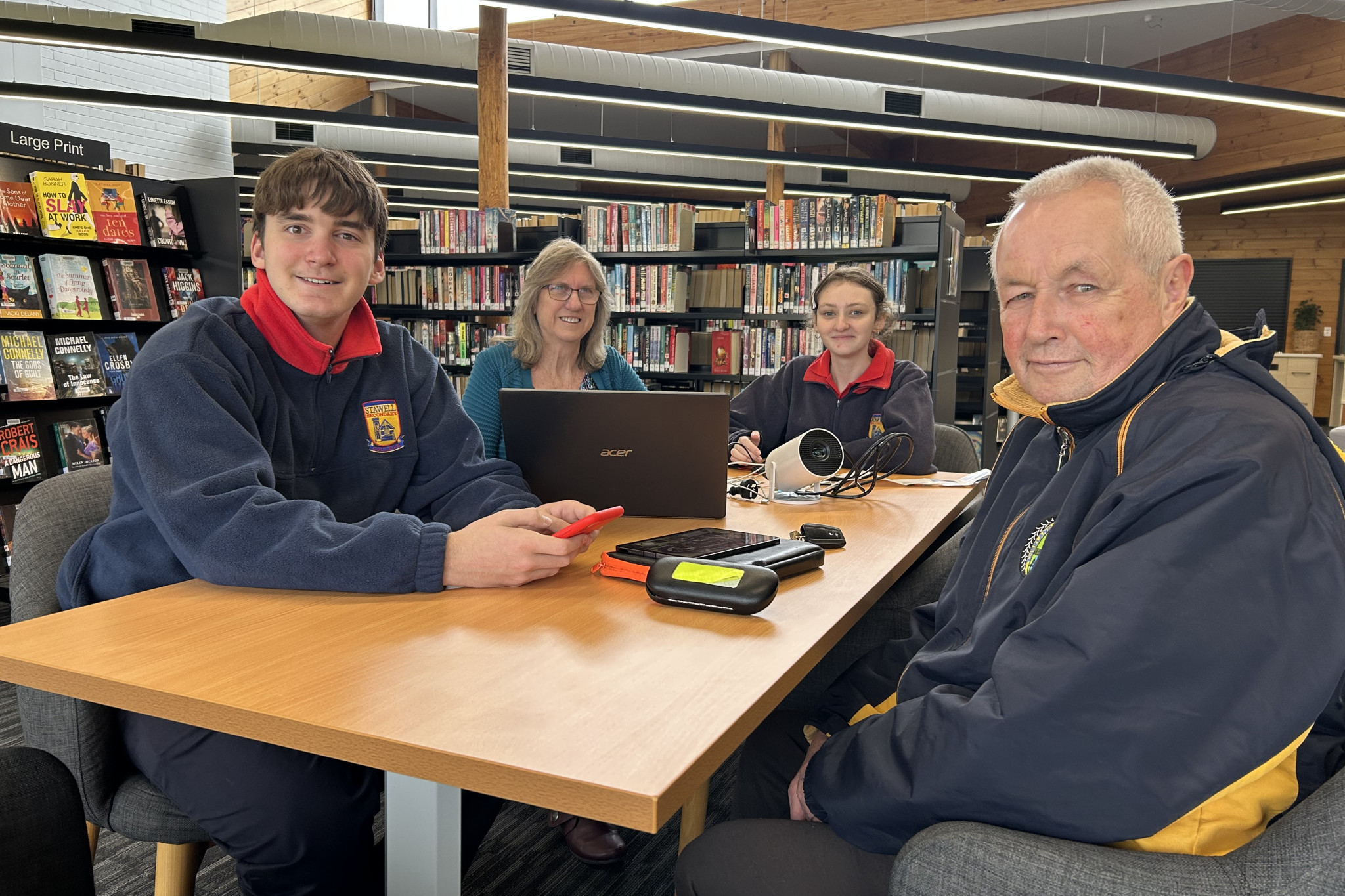 Stawell Secondary College students Sonny, left, and Siani deliver technological assistance to Debbie and John Harkin during a ‘Device Advice’ session. The sessions are on Friday mornings during school terms and you can call the library to book.