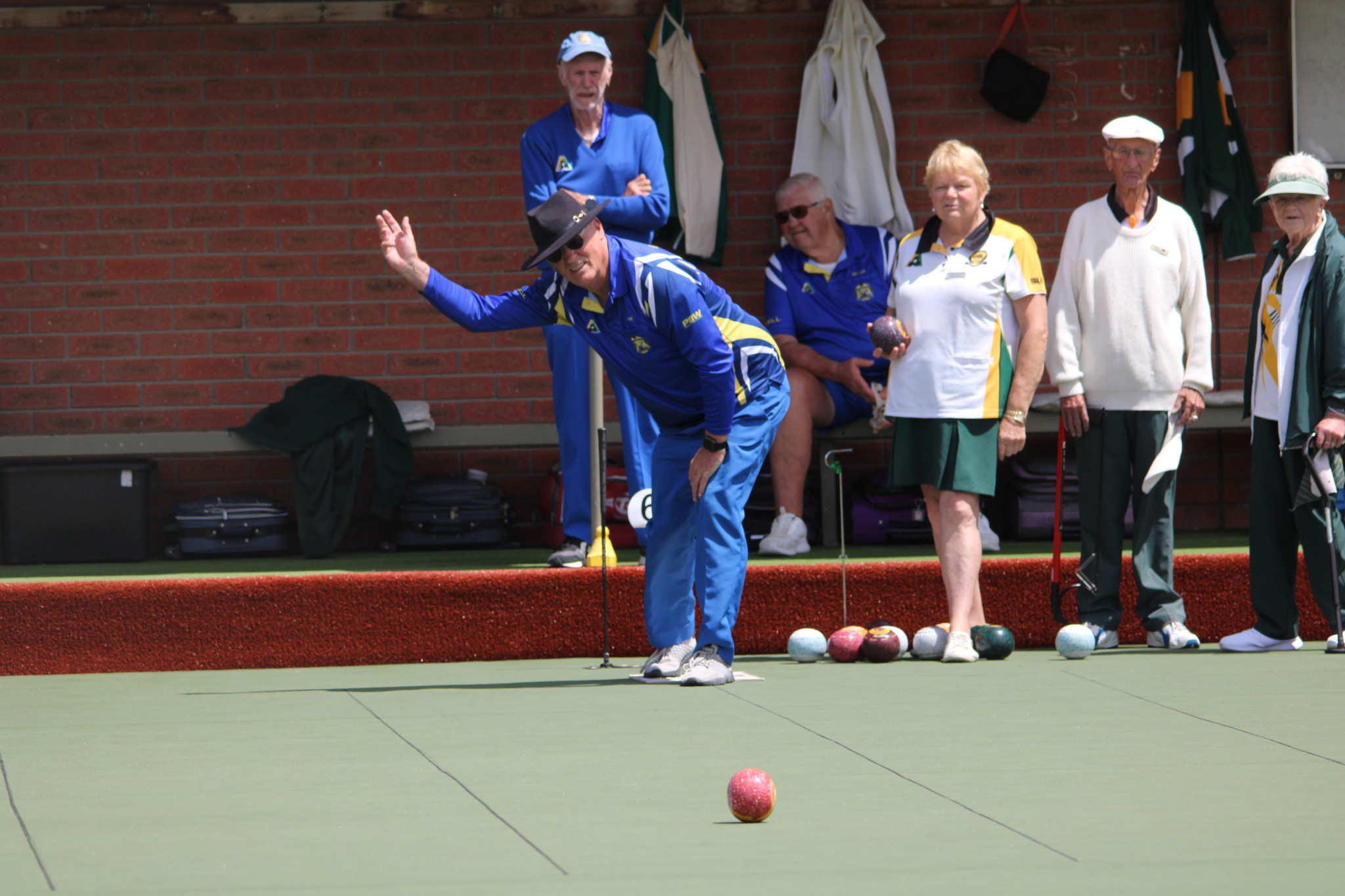 Stawell's Mark Galdes urges his bowl on as he starts off an end.