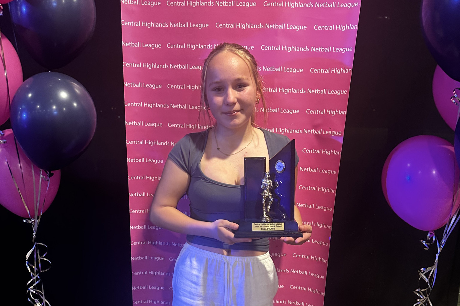 Eliza Bourke proudly shows off her trophy.