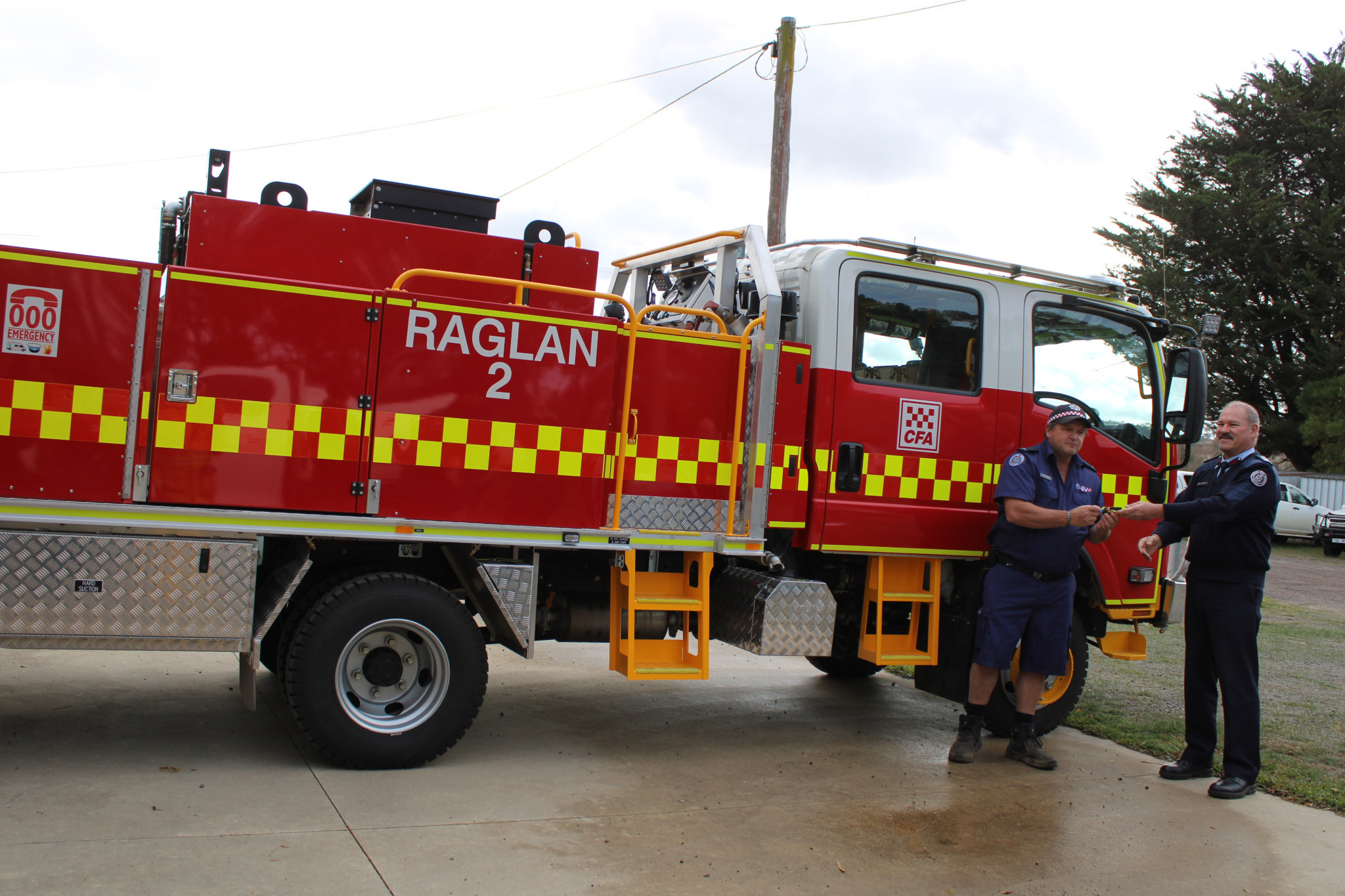 CFA Acting Deputy Chief Officer Graeme Armstrong hands the key to Raglan captain Adin Gillingham.