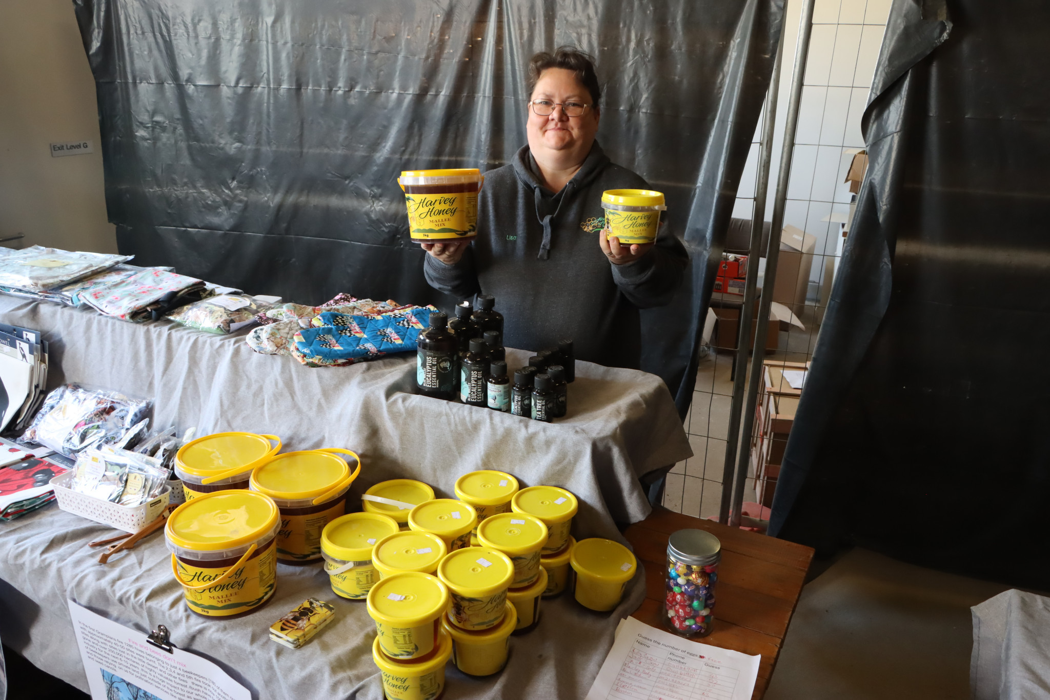 Harvey Honey is popular at local markets around the district, but the recent fires have thrown a blanket of uncertainty across the industry. Picture of Lisa Harvey with some of the products Harvey Honey sells.