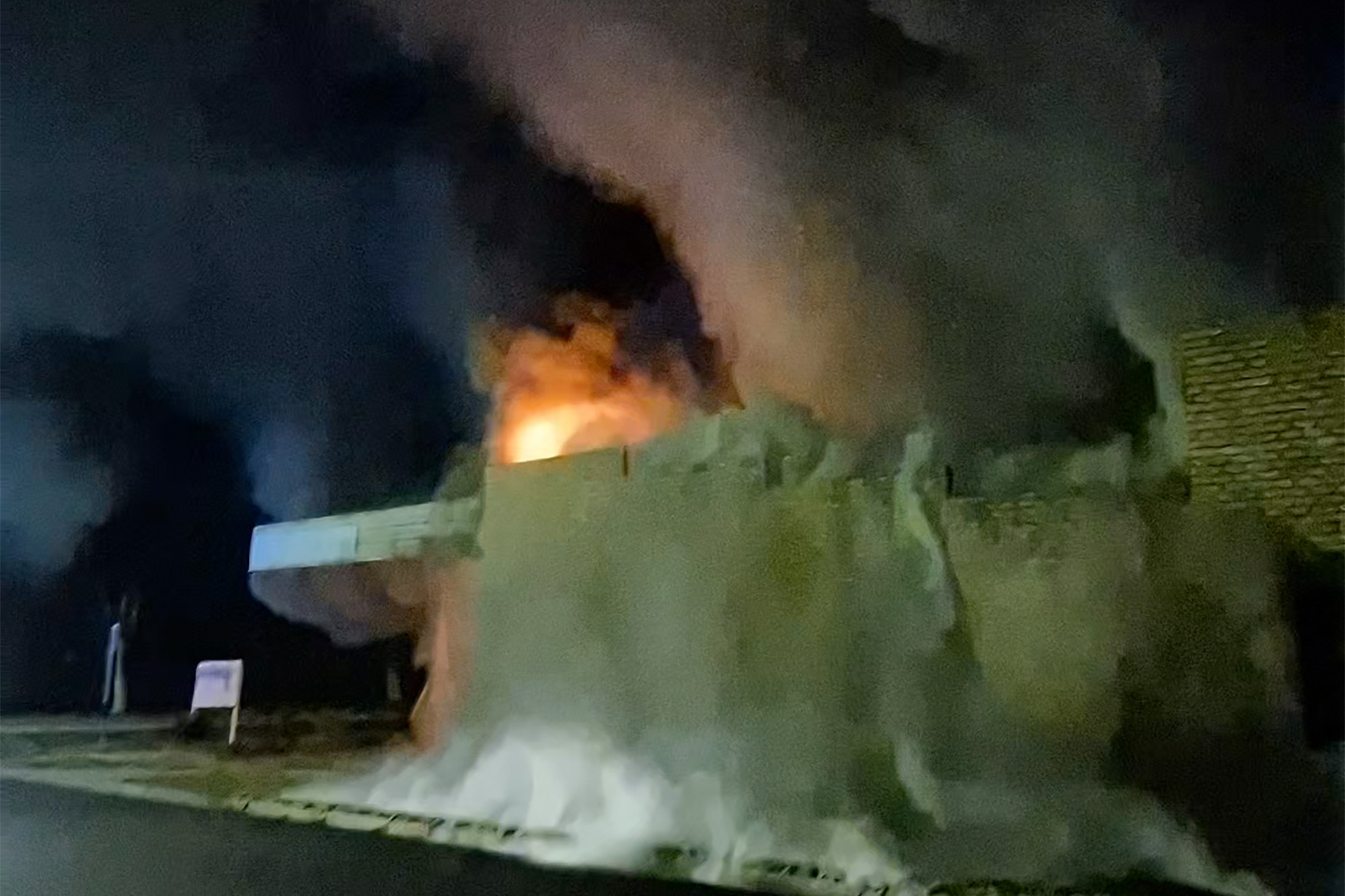 Smoke billows from the South Store as flames light up the night sky. Photo by Katie Leeke.