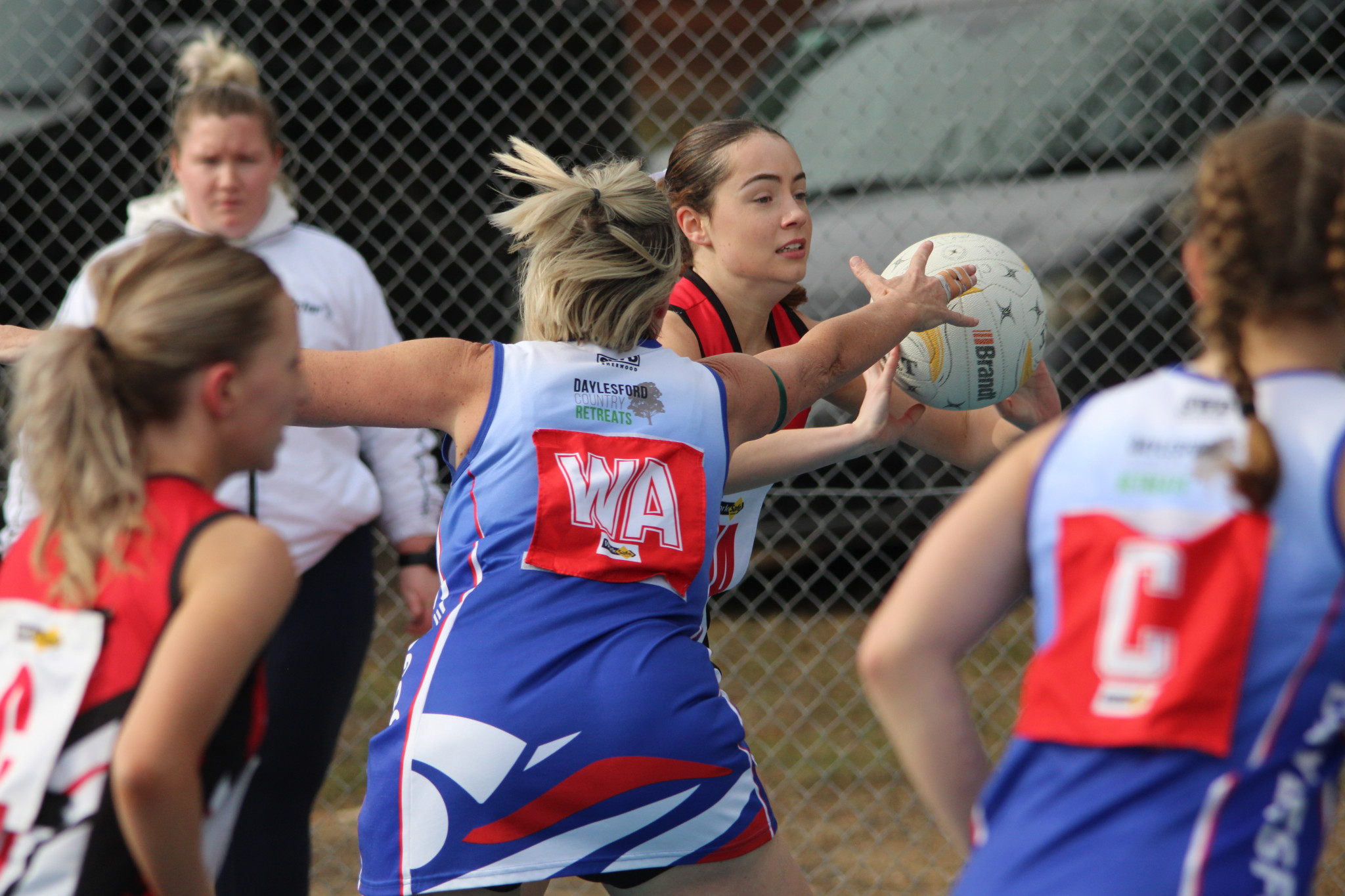 Stephanie Clark (Saints) gets a pass down court pressured by Kyra Winduss (Bulldogs). PHOTO: CHRIS GRAETZ