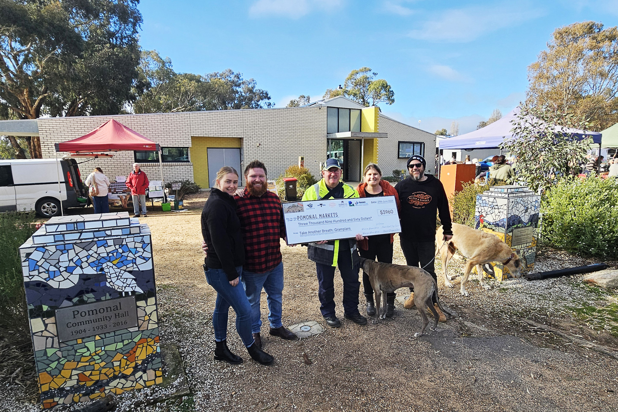 Tash Jones and Damon Henricksen, owners of Barney's Bar & Bistro hand over the cheque to John Matthews of the Pomonal Progress Association on behalf of the Pomonal Markets with Lucy and Hadyn Black from Black & Ginger Wines.