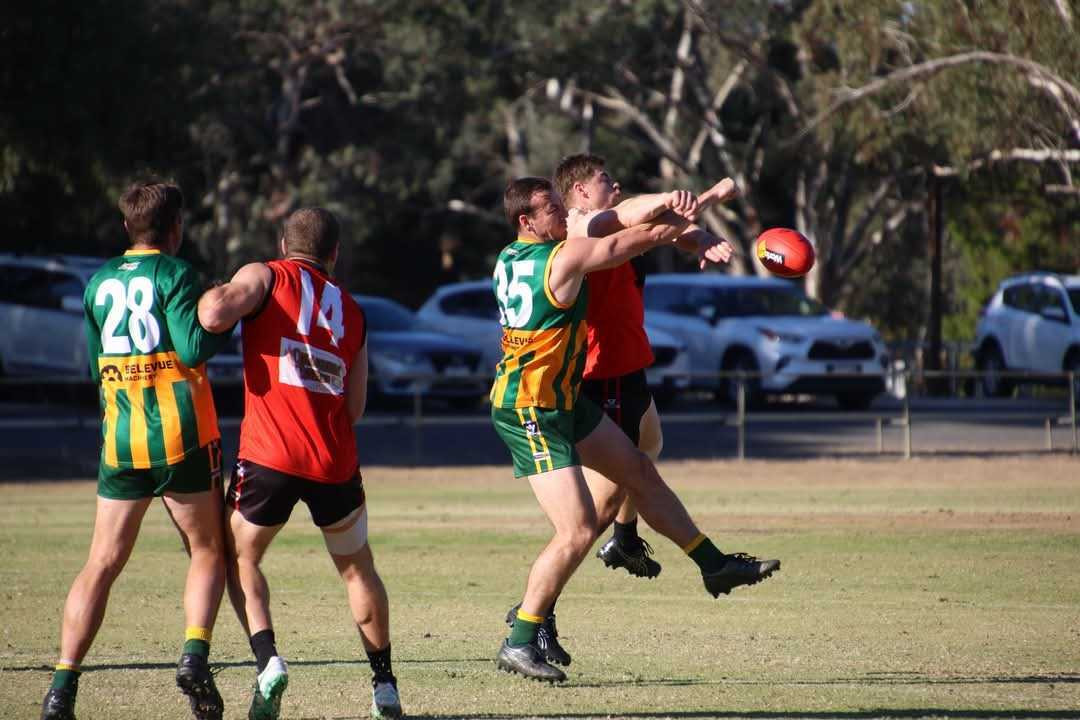 Warriors’ Cody Driscoll battles Roos Michael Pohlner for the ball.