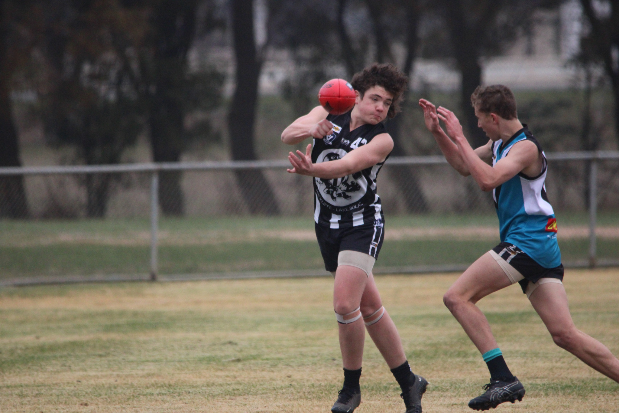 Riley Caton (Magpies) tries to get a handball away under pressure. PHOTO: CHRIS GRAETZ
