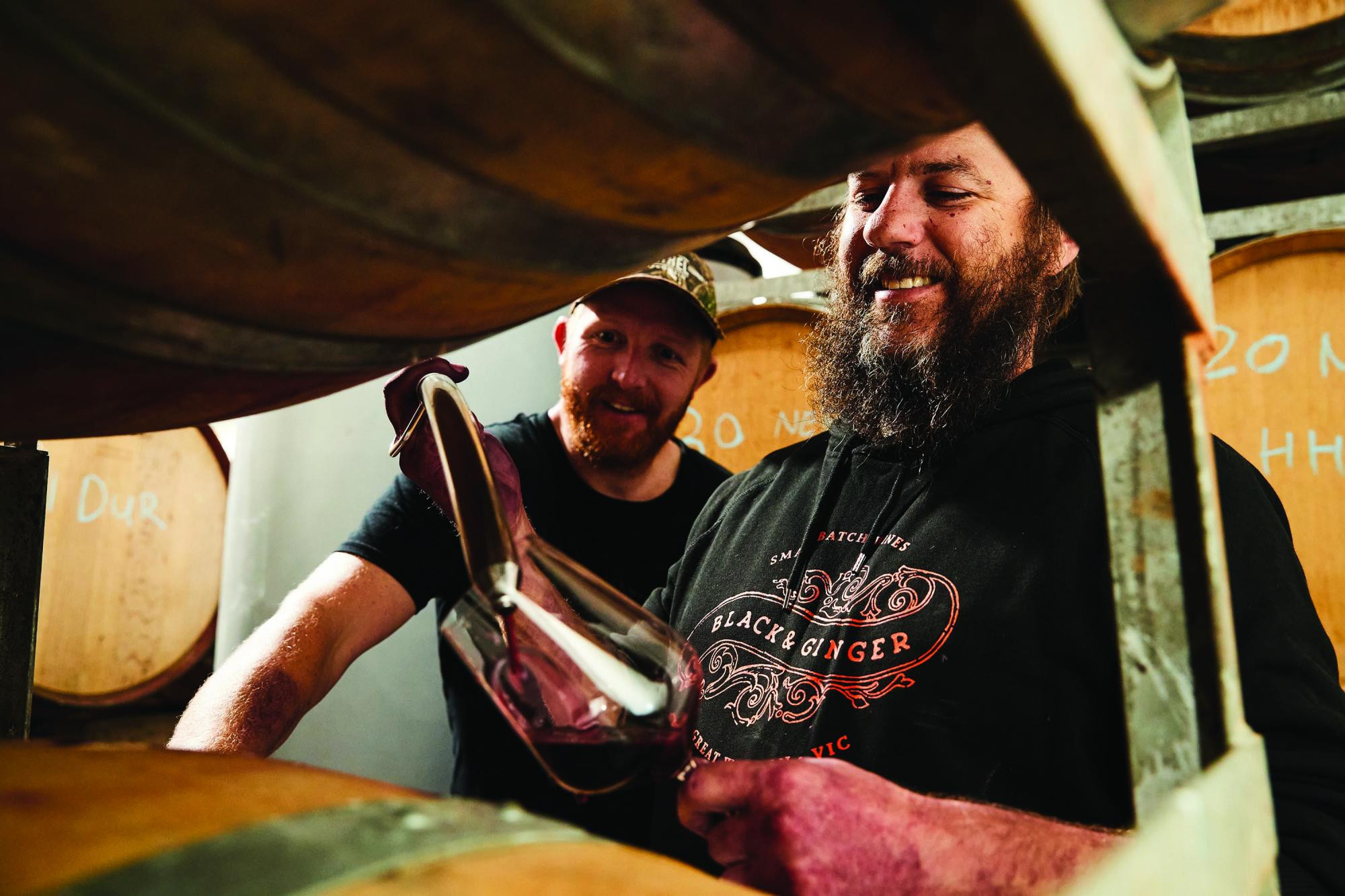 Darcy Naunton and Hadyn Black sampling a barrel of Black and Ginger wine. Picture supplied