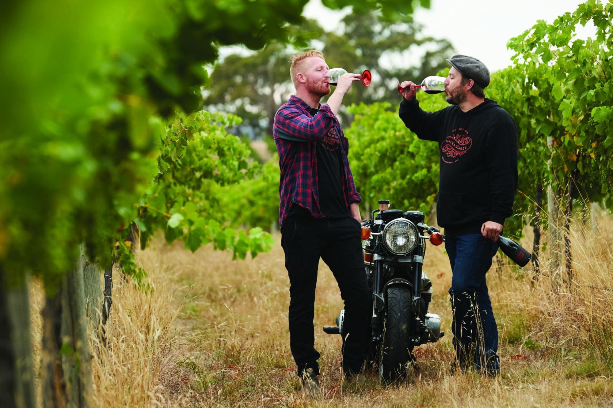 Darcy Naunton and Hadyn Black share a glass of Black and Ginger wine amongst their vines. Picture supplied