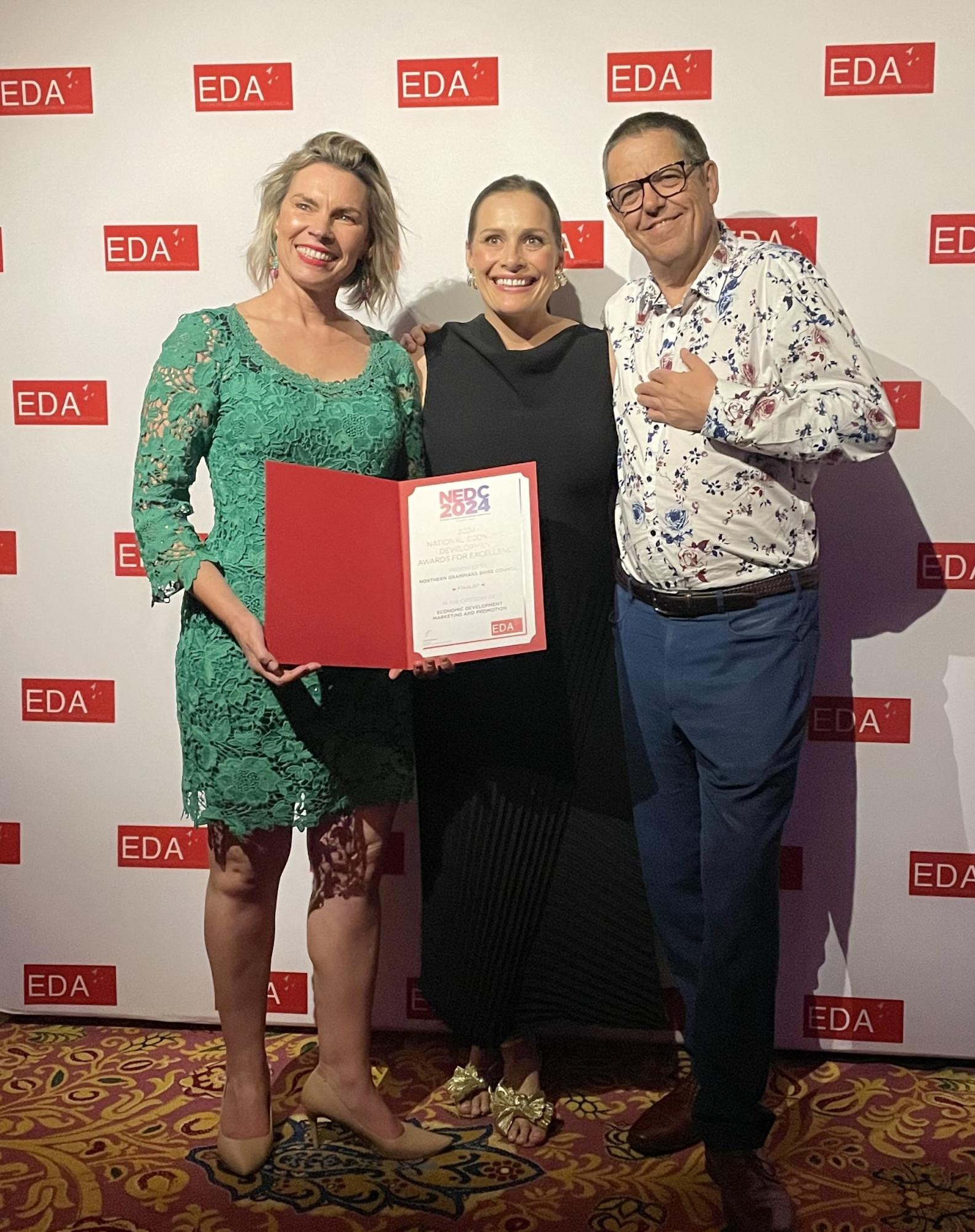 Northern Grampians Shire Council director Justine Kingan, left, tourism officer Anna Gellert and chief executive Brent McAlister celebrate the organisation being named a finalist at the 2024 National Economic Development Awards in Melbourne on October 17. Picture supplied