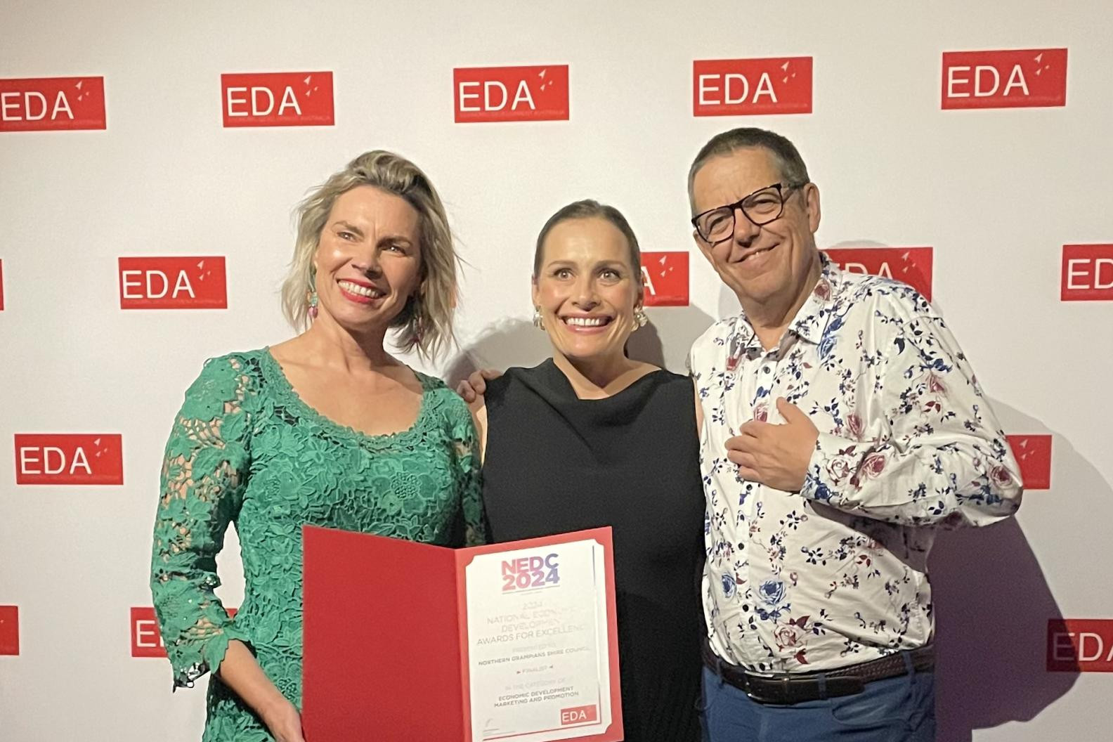 Northern Grampians Shire Council director Justine Kingan, left, tourism officer Anna Gellert and chief executive Brent McAlister celebrate the organisation being named a finalist at the 2024 National Economic Development Awards in Melbourne on October 17. Picture supplied