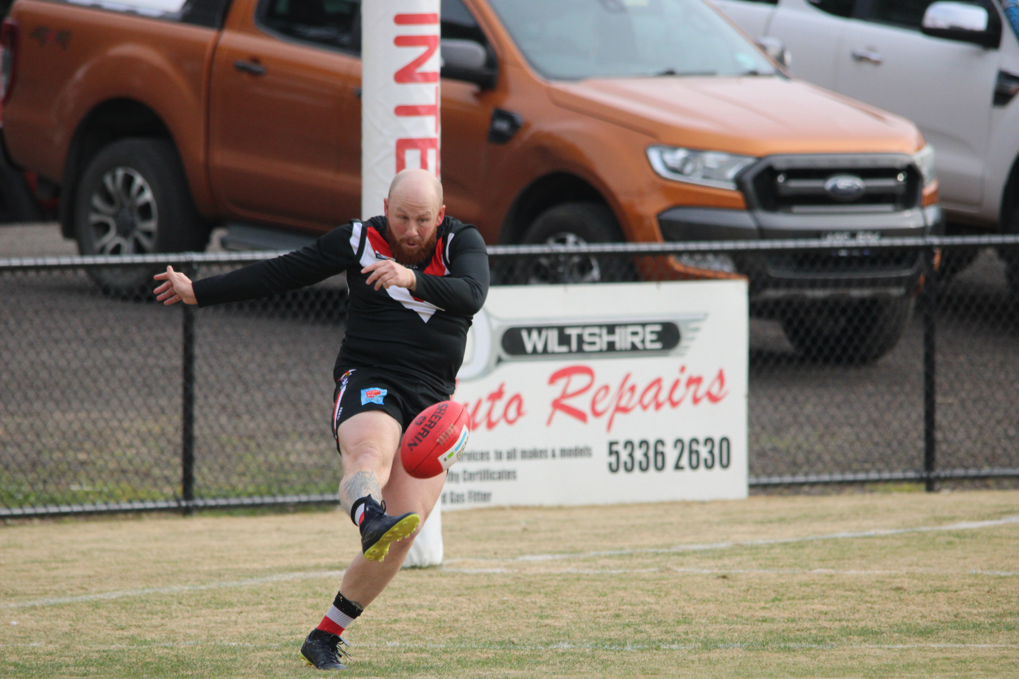 Zane Ross (Saints) gets a clearing kick away from deep in defence. PHOTO: CHRIS GRAETZ